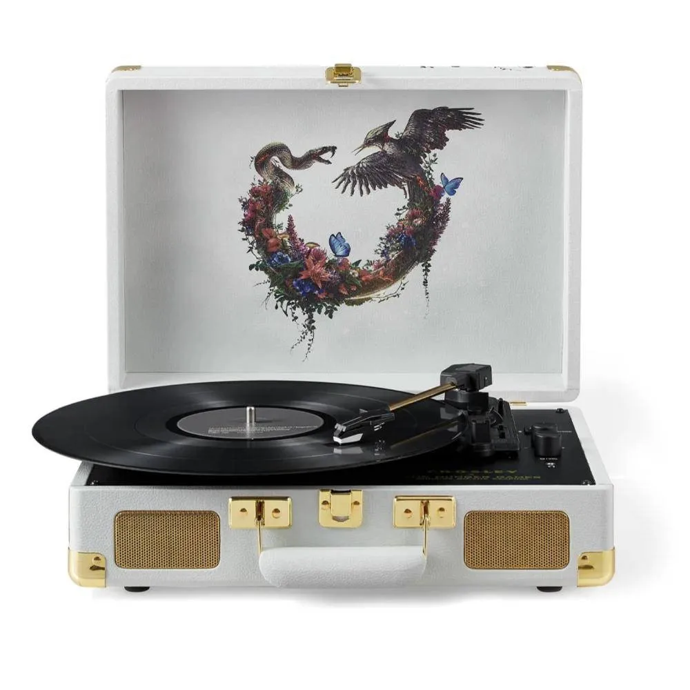 The limited edition Hunger Games Crosley Cruiser open, with the Sunrise on the Reaping lid art of a snake and a songbird circling through a ring of wildflowers above a black deck and a 7-inch record