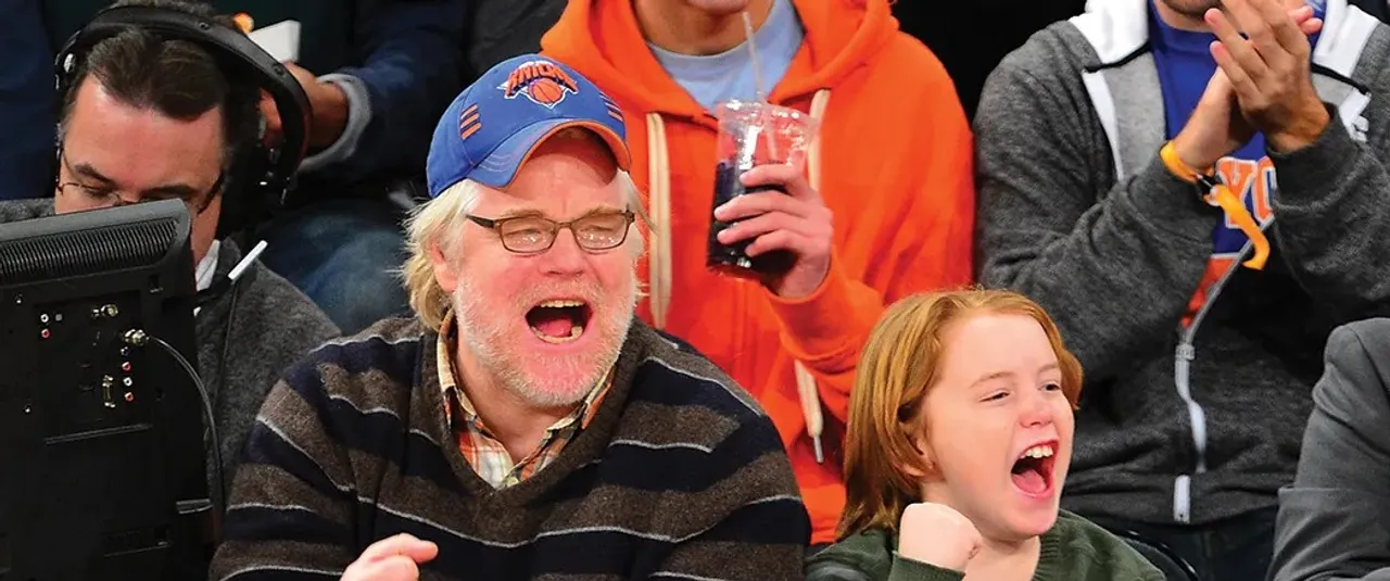 Philip Seymour Hoffman and a young Cooper Hoffman cheering courtside at a New York Knicks game